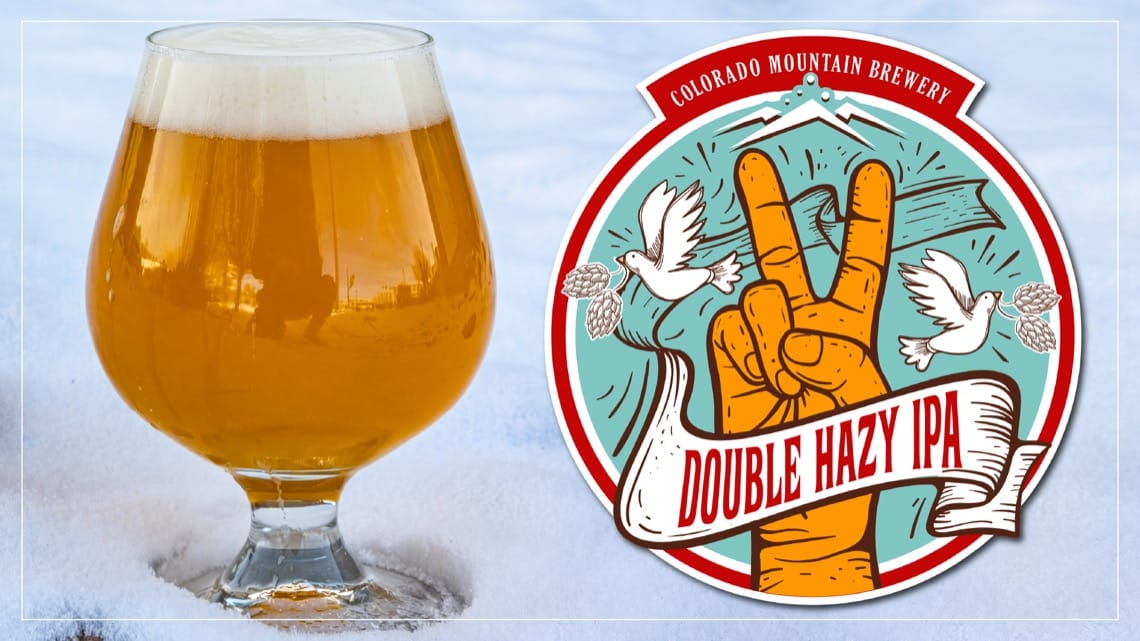 Double Hazy IPA craft beer in tulip glass with creamy white head and golden haze - Colorado Mountain Brewery seasonal release in Colorado Springs