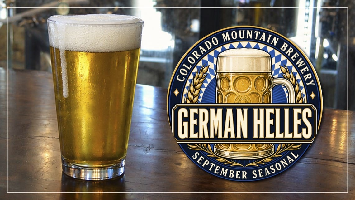 A pint of golden German Helles with a thick white head on a wooden bar, next to the Colorado Mountain Brewery September Seasonal German Helles logo.